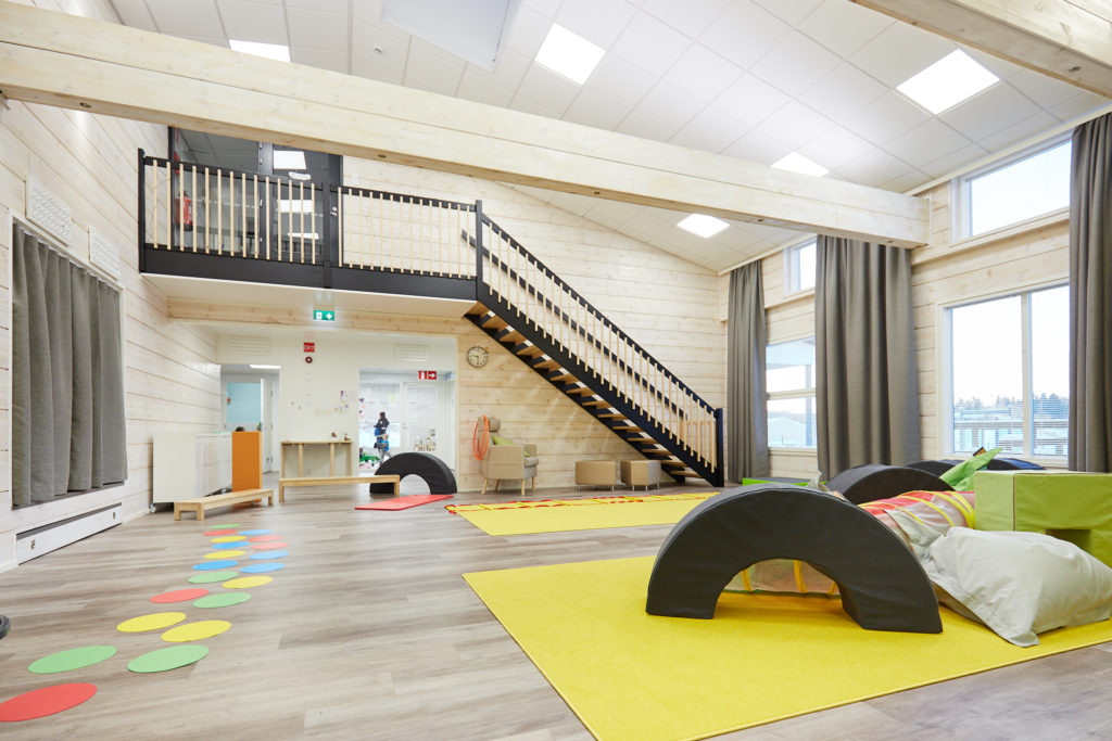 Playroom with access to the staircase upstairs.